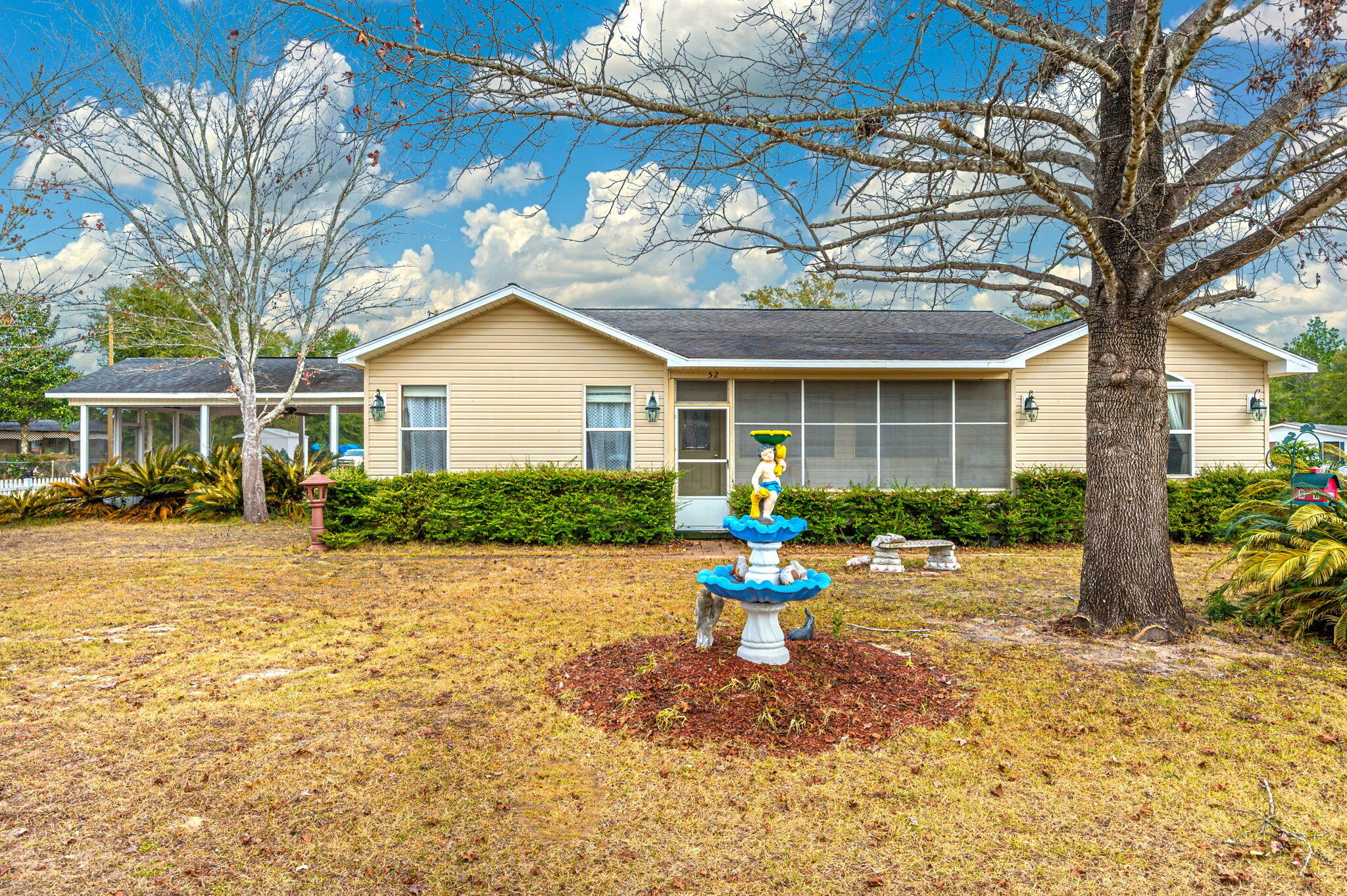 52 Tulip Avenue DeFuniak Springs, FL 32433 - Photo 32 of 34 a front view of a house with a yard and sitting area