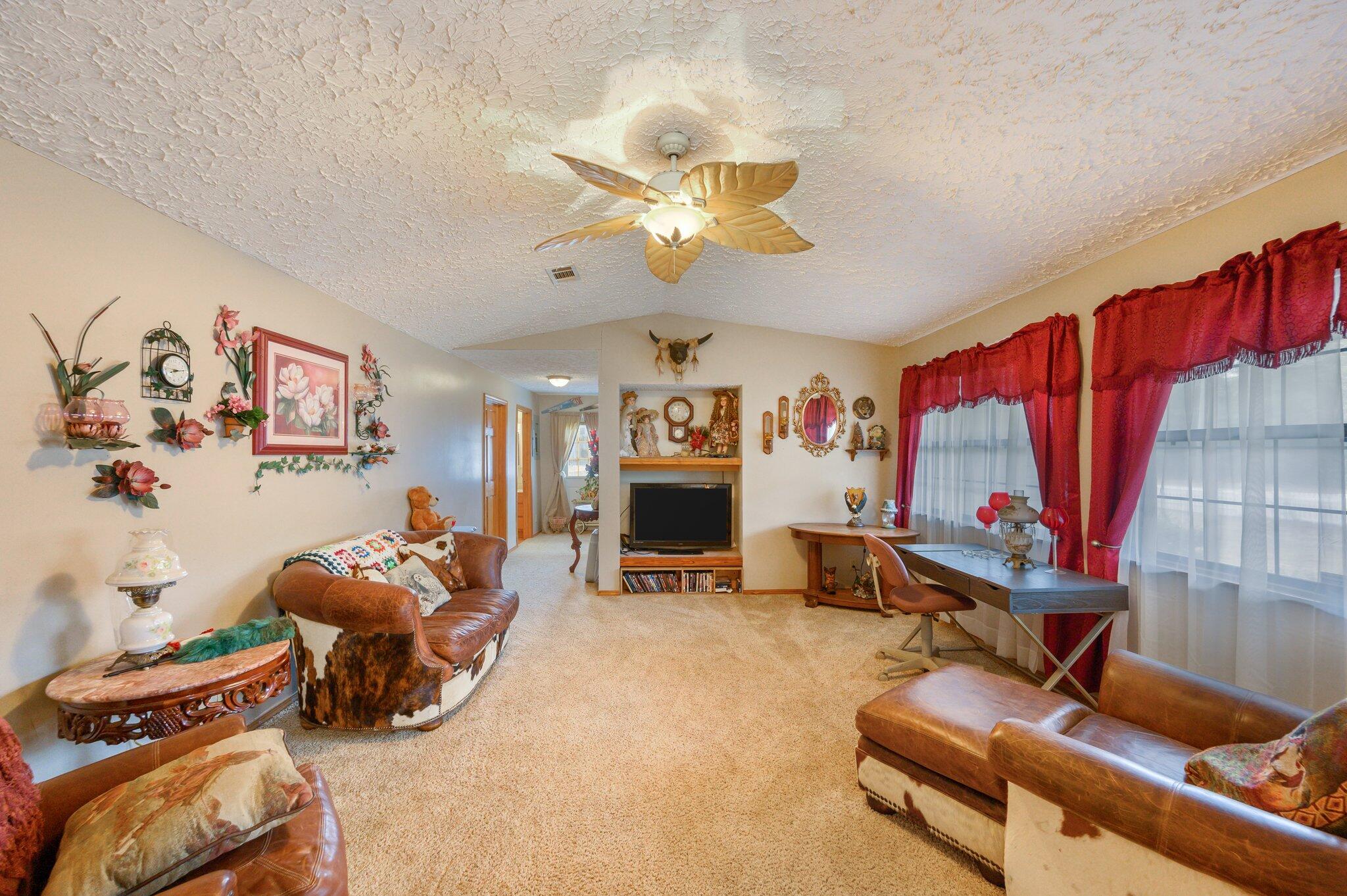 52 Tulip Avenue DeFuniak Springs, FL 32433 - Photo 4 of 34 a living room with furniture a flat screen tv and a fireplace