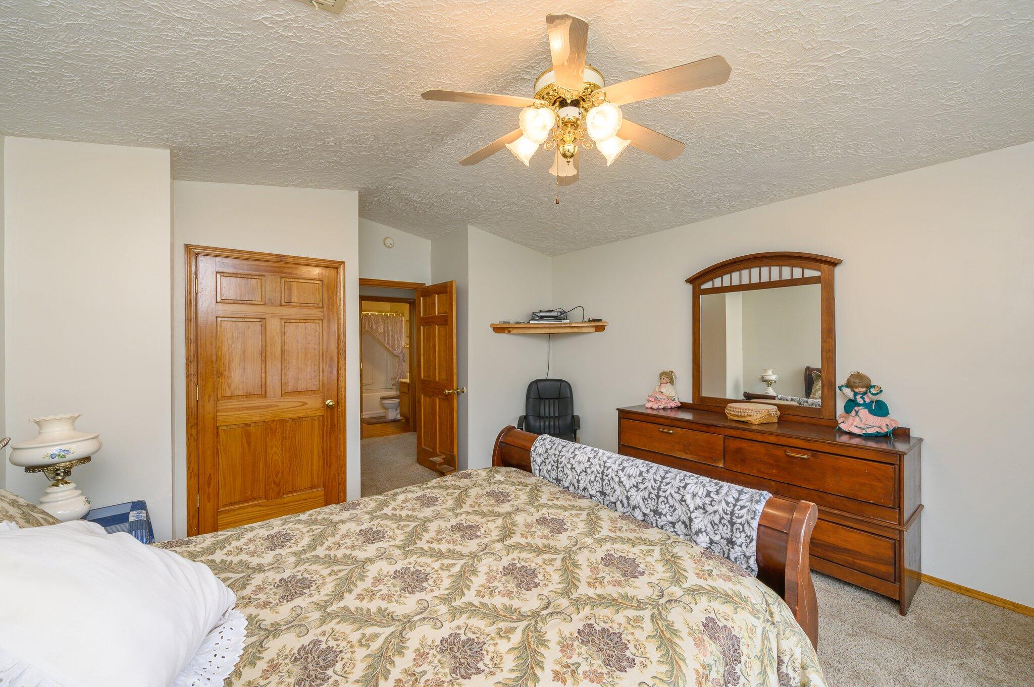 52 Tulip Avenue DeFuniak Springs, FL 32433 - Photo 7 of 34 a bedroom with a bed and a chandelier