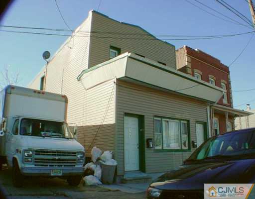 369 Grove Street Perth Amboy, NJ 08861 - Photo 1 of 2 a front view of a house with a garden