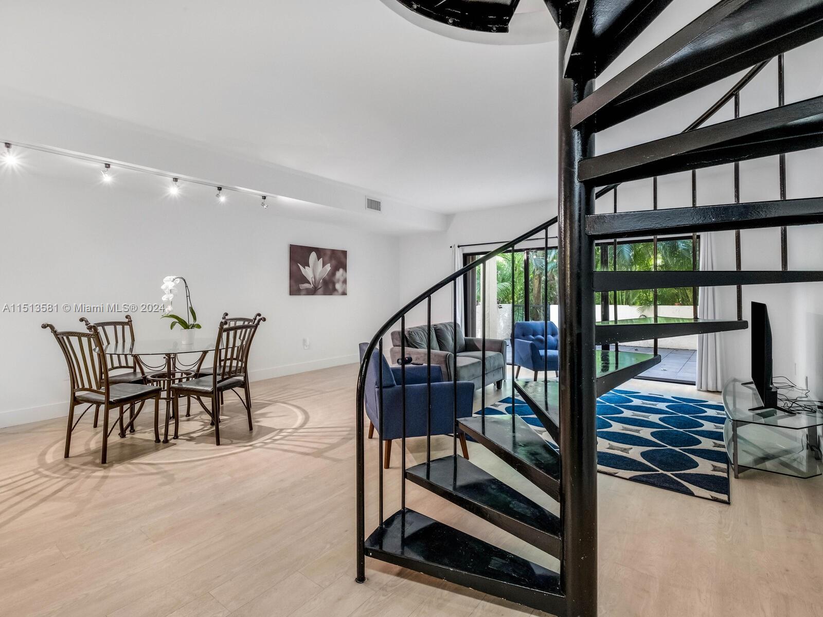 2430 Brickell Avenue, Unit 105A Miami, FL 33129 - Photo 12 of 27 a view of a livingroom with furniture wooden floor and windows