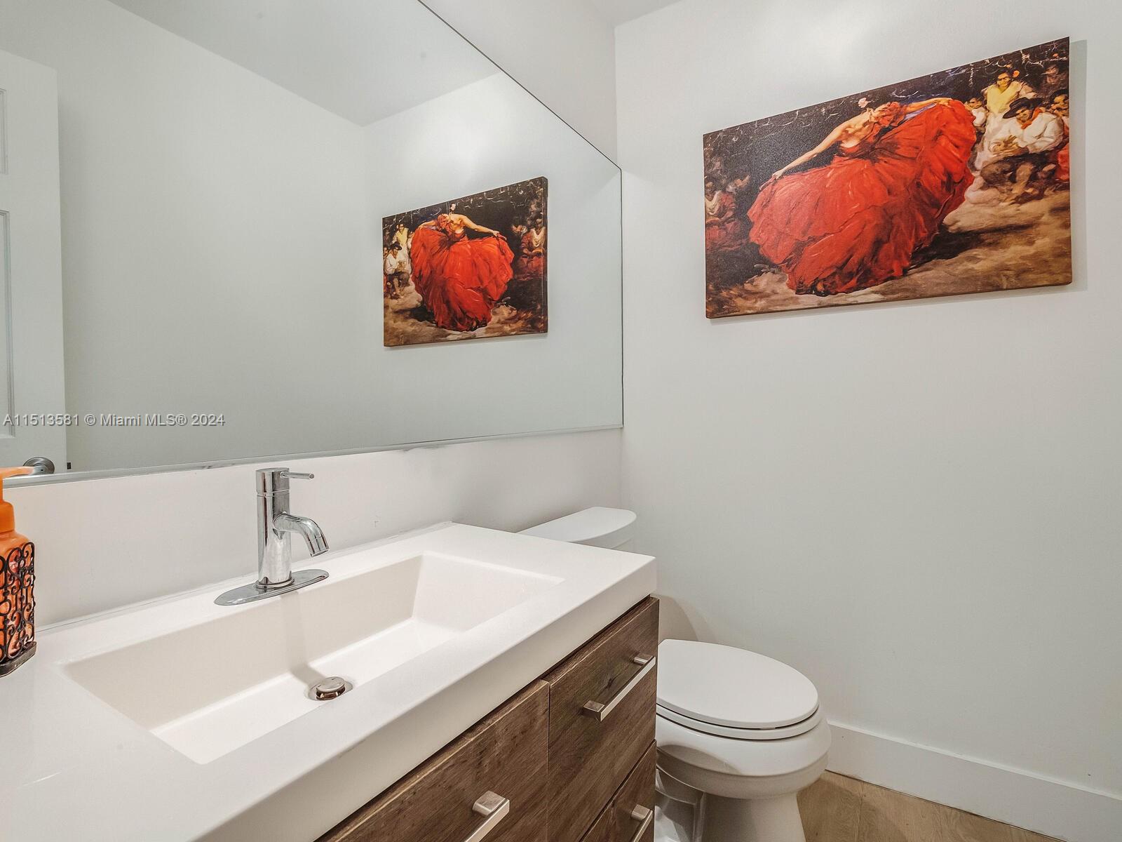 2430 Brickell Avenue, Unit 105A Miami, FL 33129 - Photo 13 of 27 a bathroom with a sink and a mirror