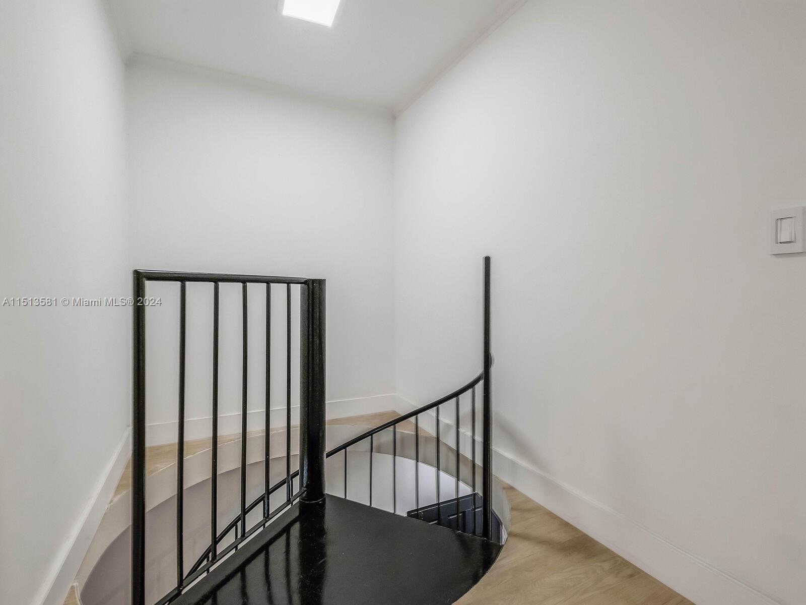 2430 Brickell Avenue, Unit 105A Miami, FL 33129 - Photo 14 of 27 a view of staircase with railing and white walls