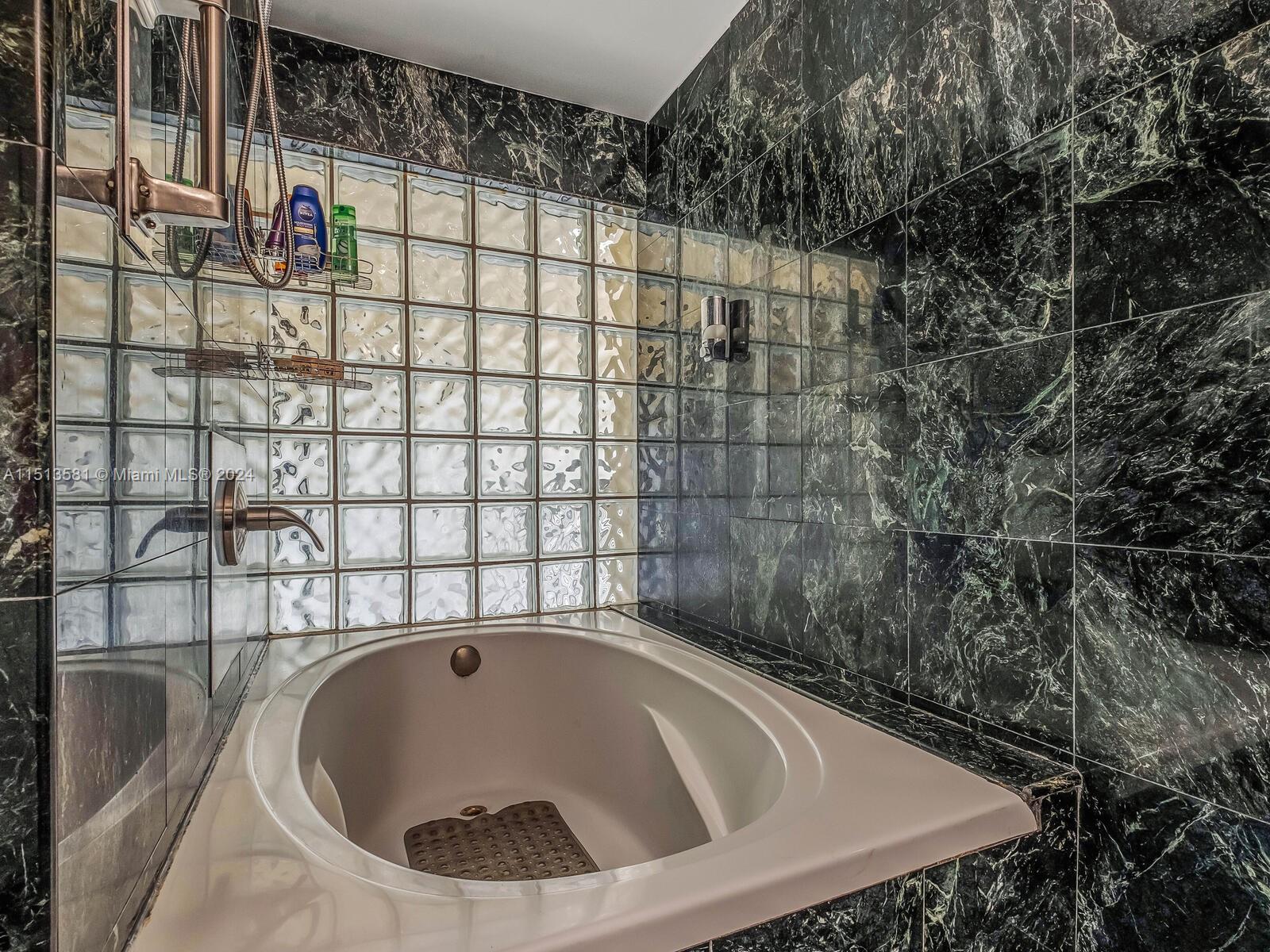 2430 Brickell Avenue, Unit 105A Miami, FL 33129 - Photo 18 of 27 a bathroom with a bathtub