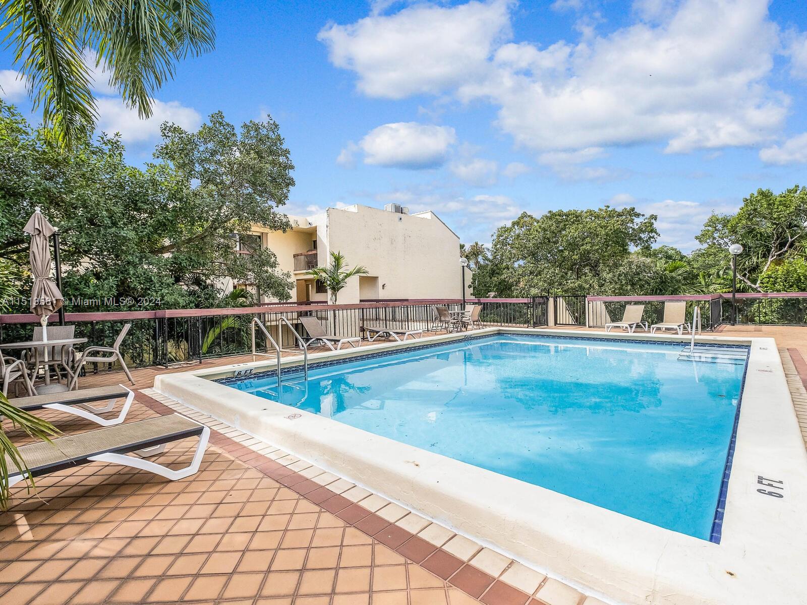 2430 Brickell Avenue, Unit 105A Miami, FL 33129 - Photo 24 of 27 a view of a swimming pool with a lounge chairs