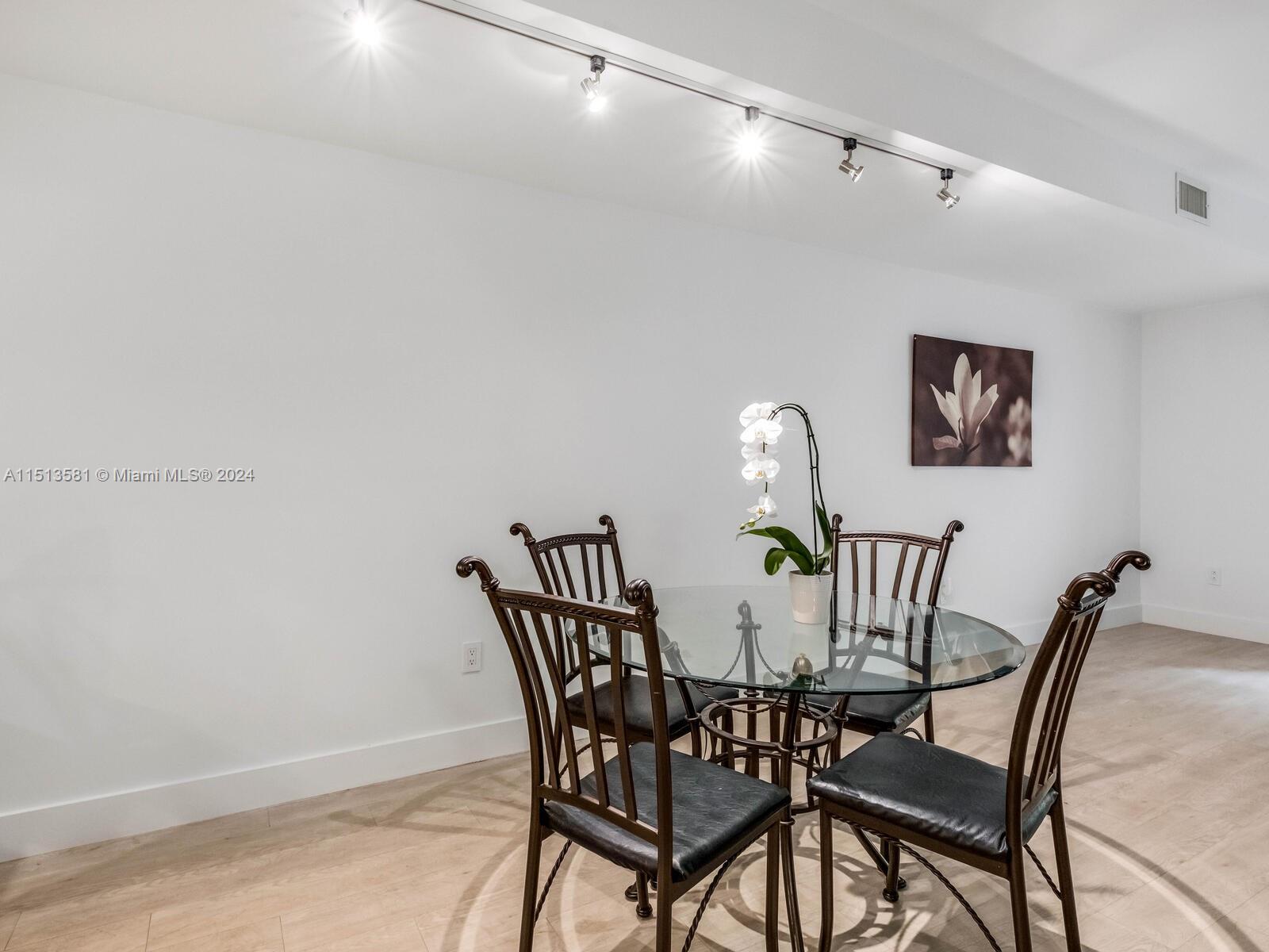 2430 Brickell Avenue, Unit 105A Miami, FL 33129 - Photo 5 of 27 a view of a dining room with furniture and window