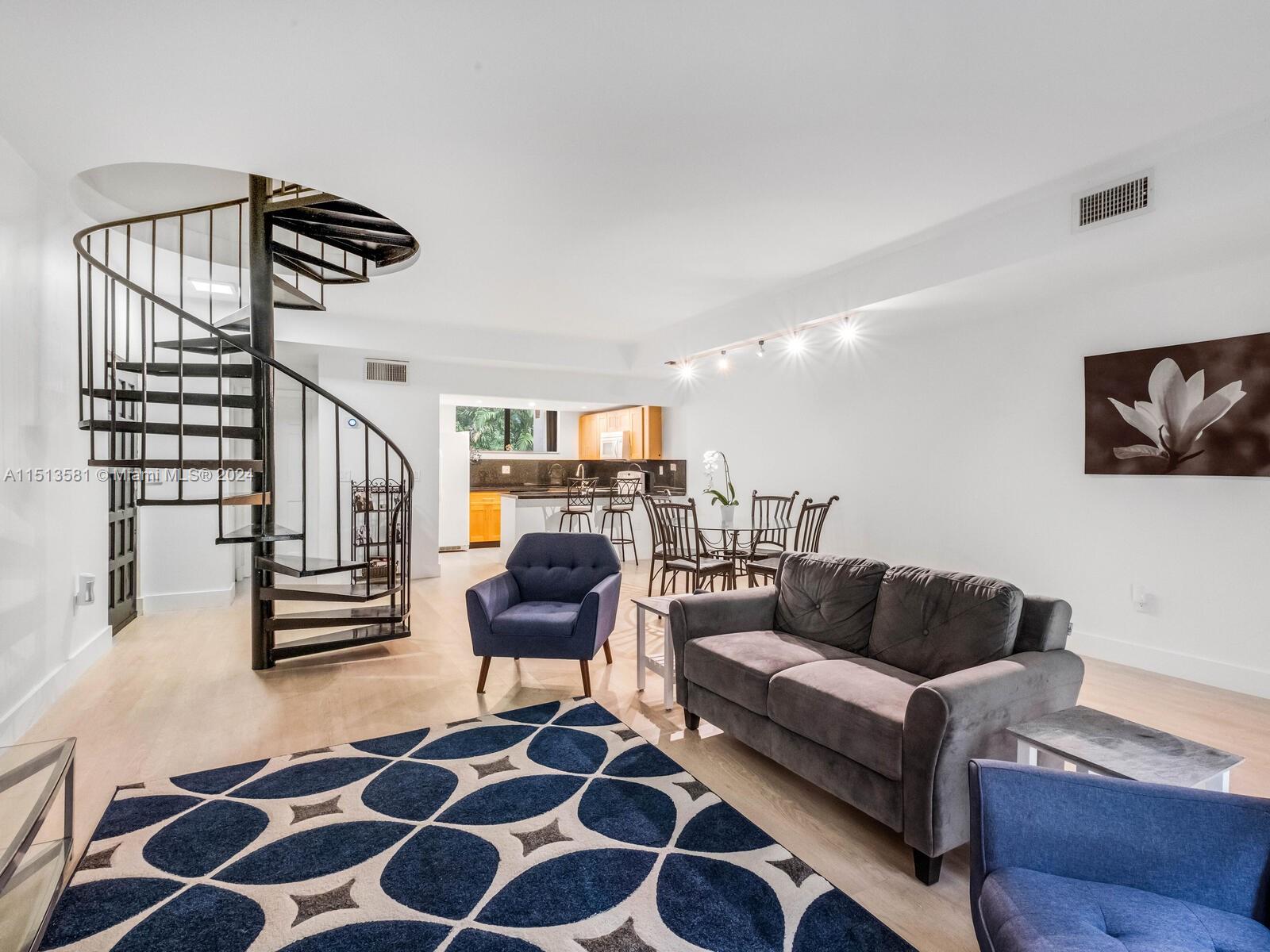 2430 Brickell Avenue, Unit 105A Miami, FL 33129 - Photo 10 of 27 a living room with furniture and a flat screen tv