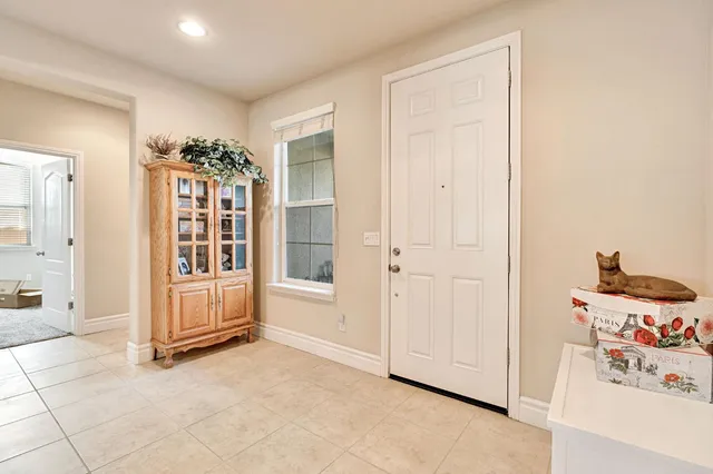 an entryway with a cabinet and mirrors