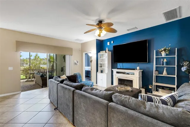 a living room with fireplace furniture and a flat screen tv