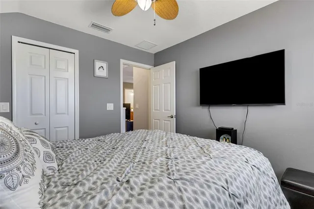 a bedroom with a bed and a flat screen tv