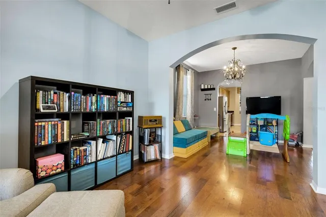 a view of a livingroom with furniture and bookshelf