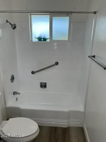 a bathroom with a toilet and a shower