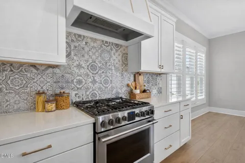 a kitchen with stainless steel appliances granite countertop a sink and cabinets