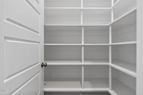 a view of a livingroom with furniture wooden floor and a chandelier