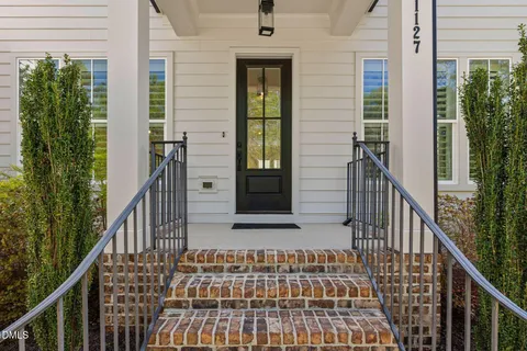 a living room with furniture fireplace and a large window