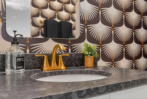 a view of an empty room with wooden floor and a ceiling fan