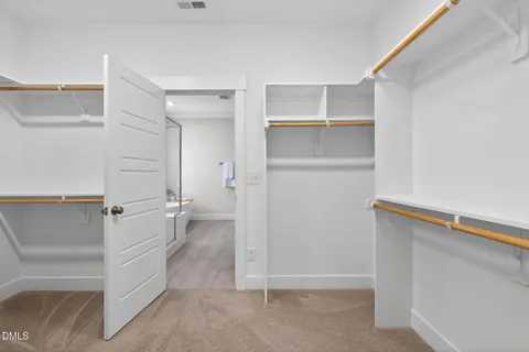 a bathroom with a double vanity sink toilet mirror and bathtub