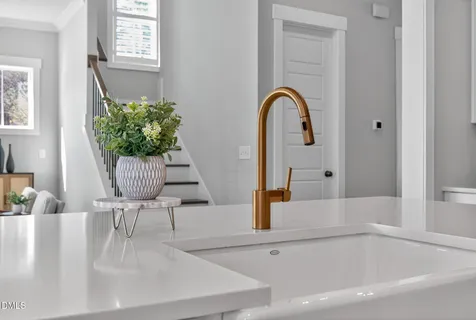 a view of a dining room and livingroom with furniture wooden floor a chandelier