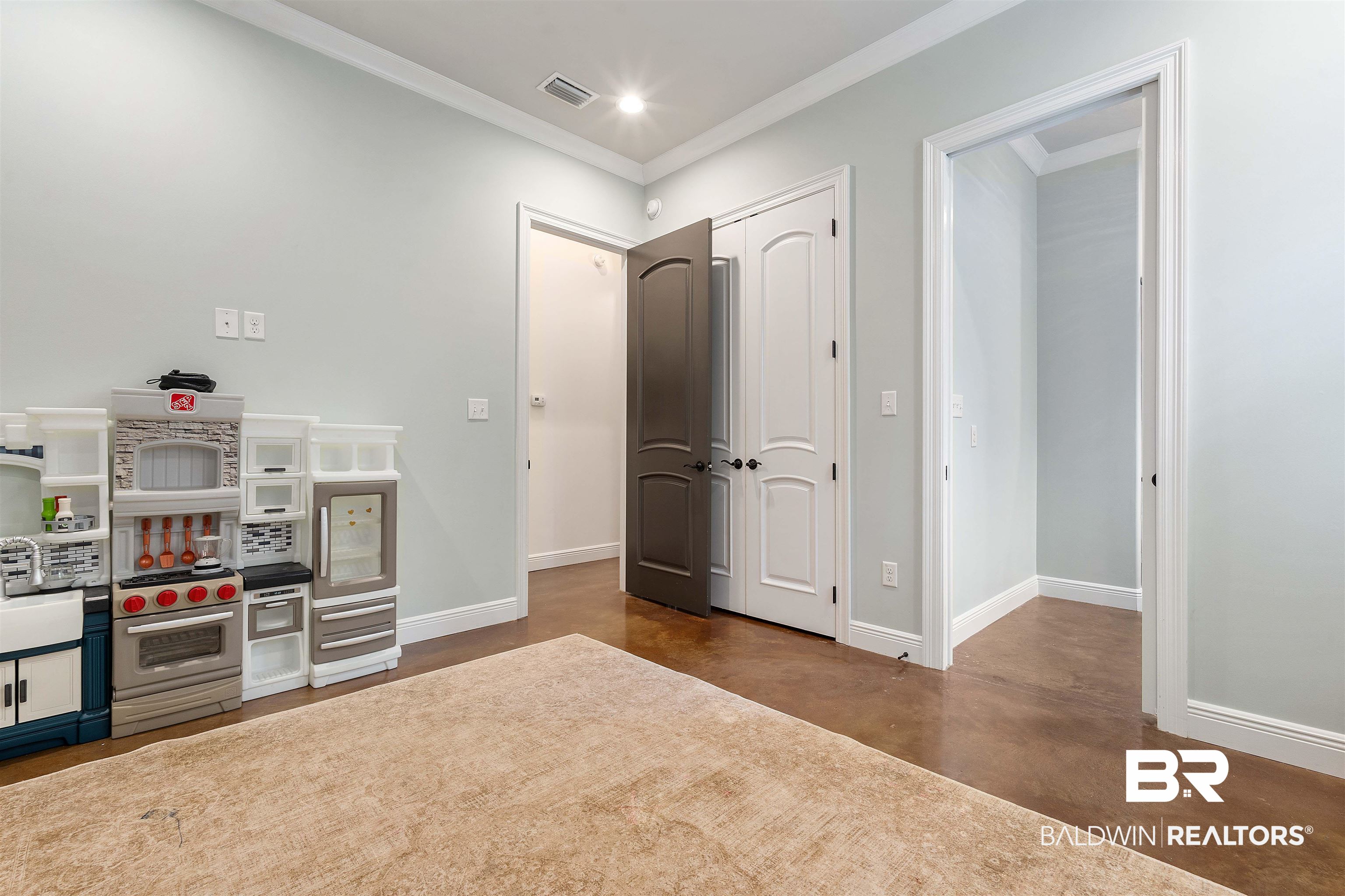 3584 Rue Royal Mobile, AL 36693 - Photo 25 of 35 Playroom with visible vents, finished concrete flooring, crown molding, baseboards, and recessed lighting