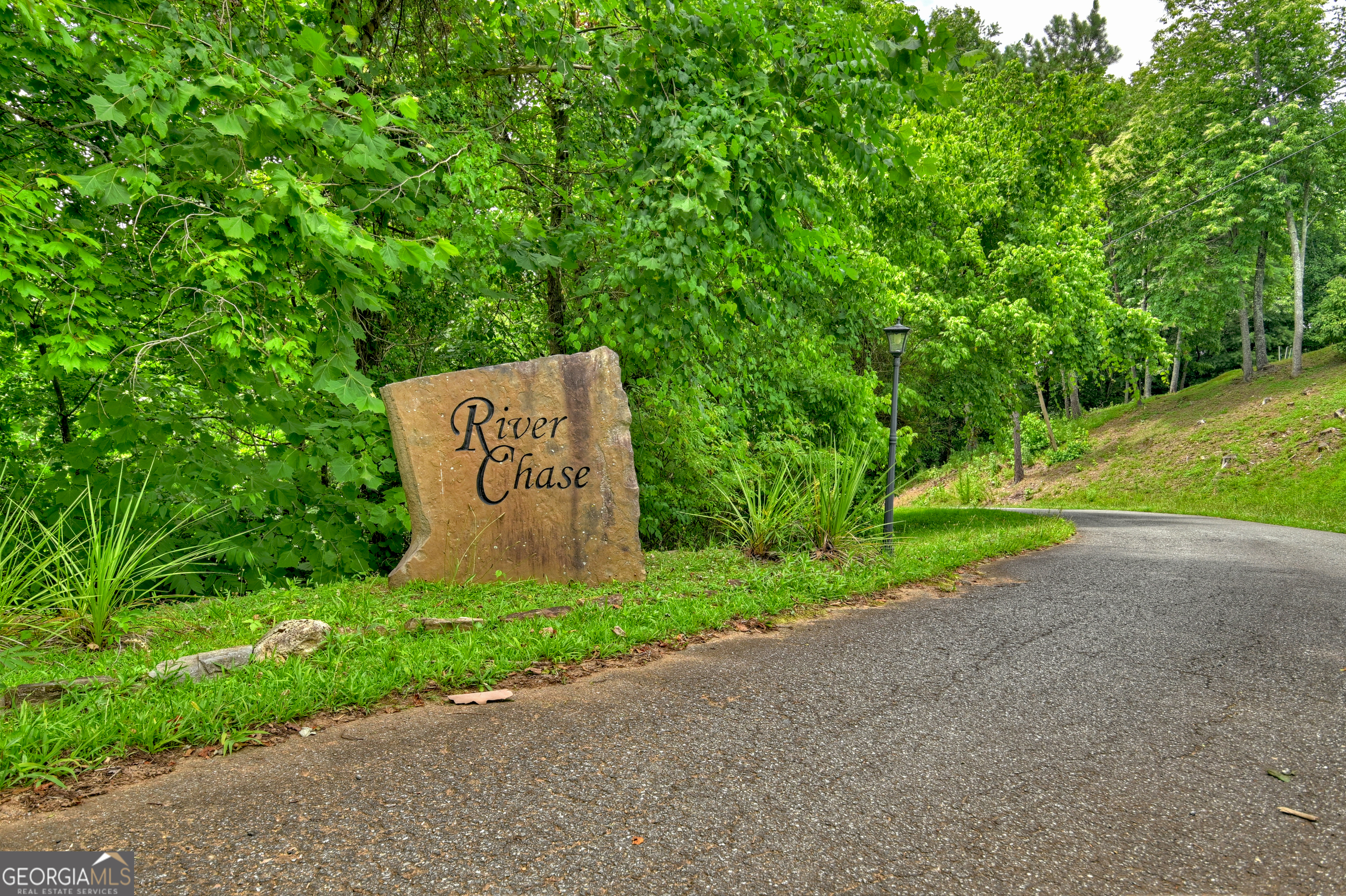 Lot 4 Mountain Trace Ellijay, GA 30540 - Photo 2 of 16 a sign board with tall trees