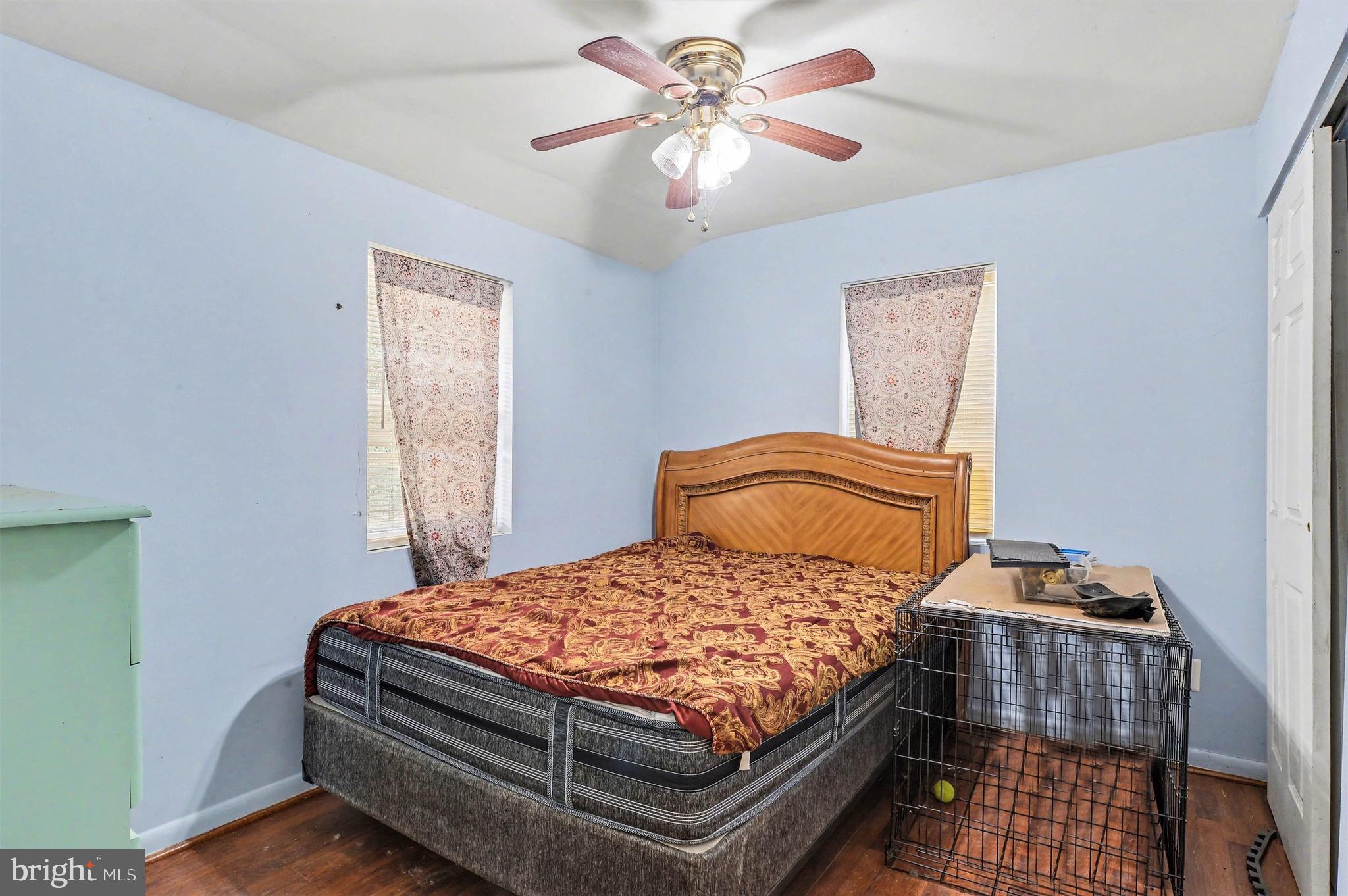 1220 Shesley Road Edgewater, MD 21037 - Photo 16 of 22 a bedroom with a bed and a chandelier