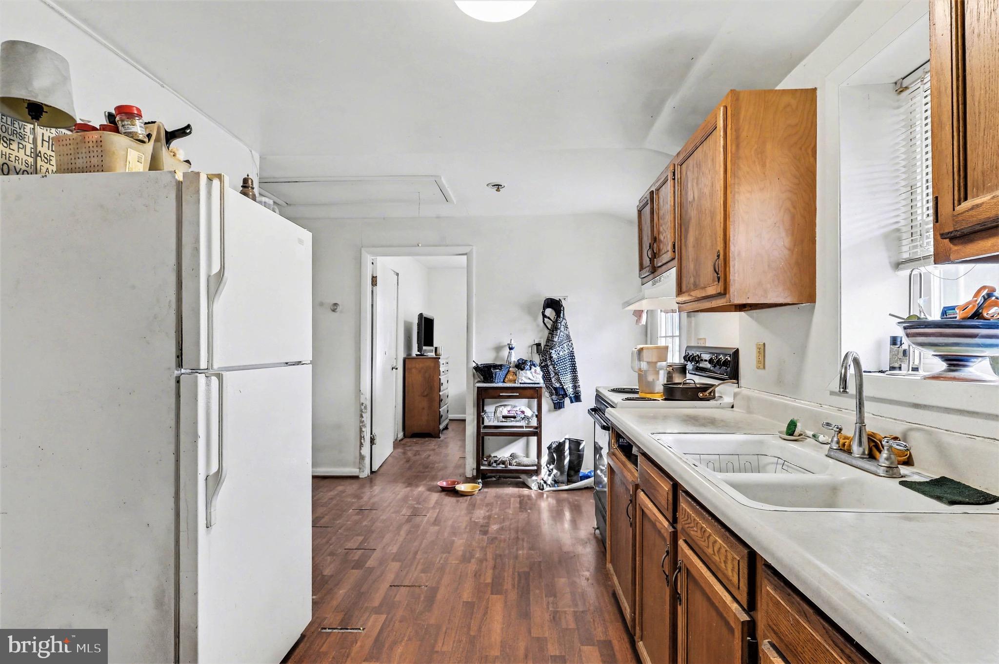 1220 Shesley Road Edgewater, MD 21037 - Photo 9 of 22 a kitchen with a refrigerator a sink and wooden floor