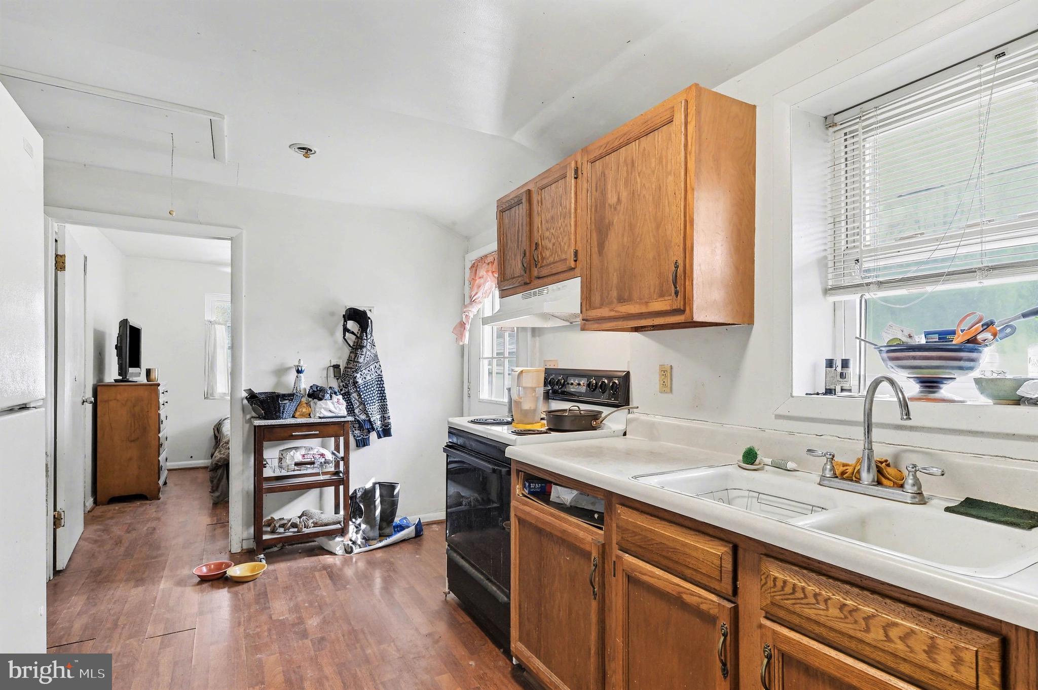 1220 Shesley Road Edgewater, MD 21037 - Photo 10 of 22 a kitchen with a sink cabinets and wooden floor