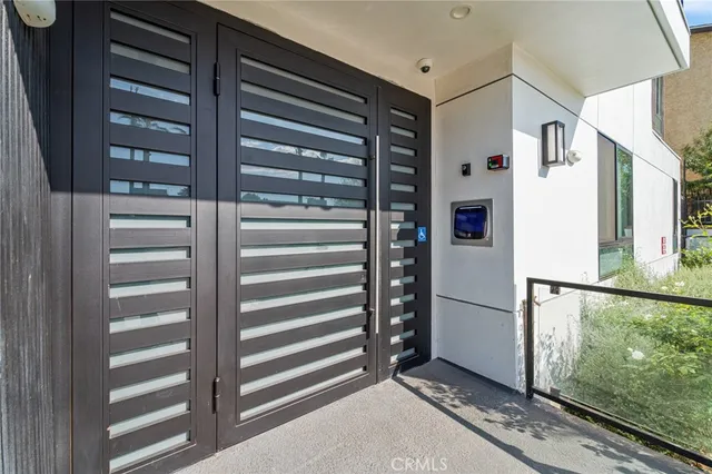 a view of kitchen with stainless steel appliances cabinets and a window