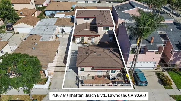 an aerial view of houses with an outdoor space