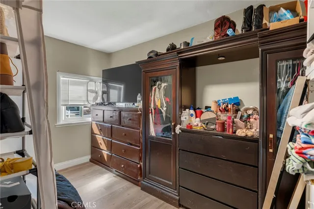 a kitchen with stainless steel appliances granite countertop a stove a refrigerator a dining table and chairs