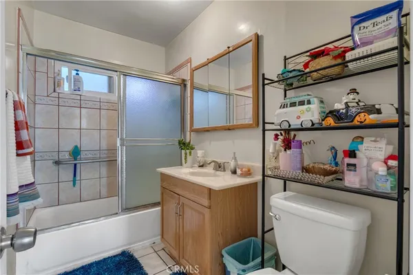 a kitchen with a sink a refrigerator and cabinets
