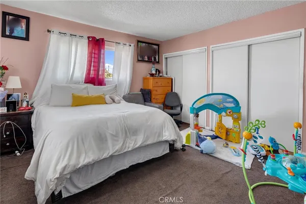 a bedroom that has a bed and a tv in it