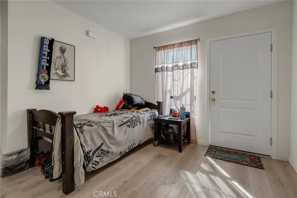 a kitchen with stainless steel appliances granite countertop a stove a refrigerator a dining table and chairs