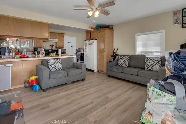 a kitchen with lots of clutter and stainless steel appliances