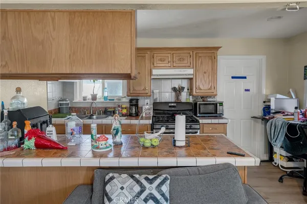 a kitchen with a stove a sink and a refrigerator
