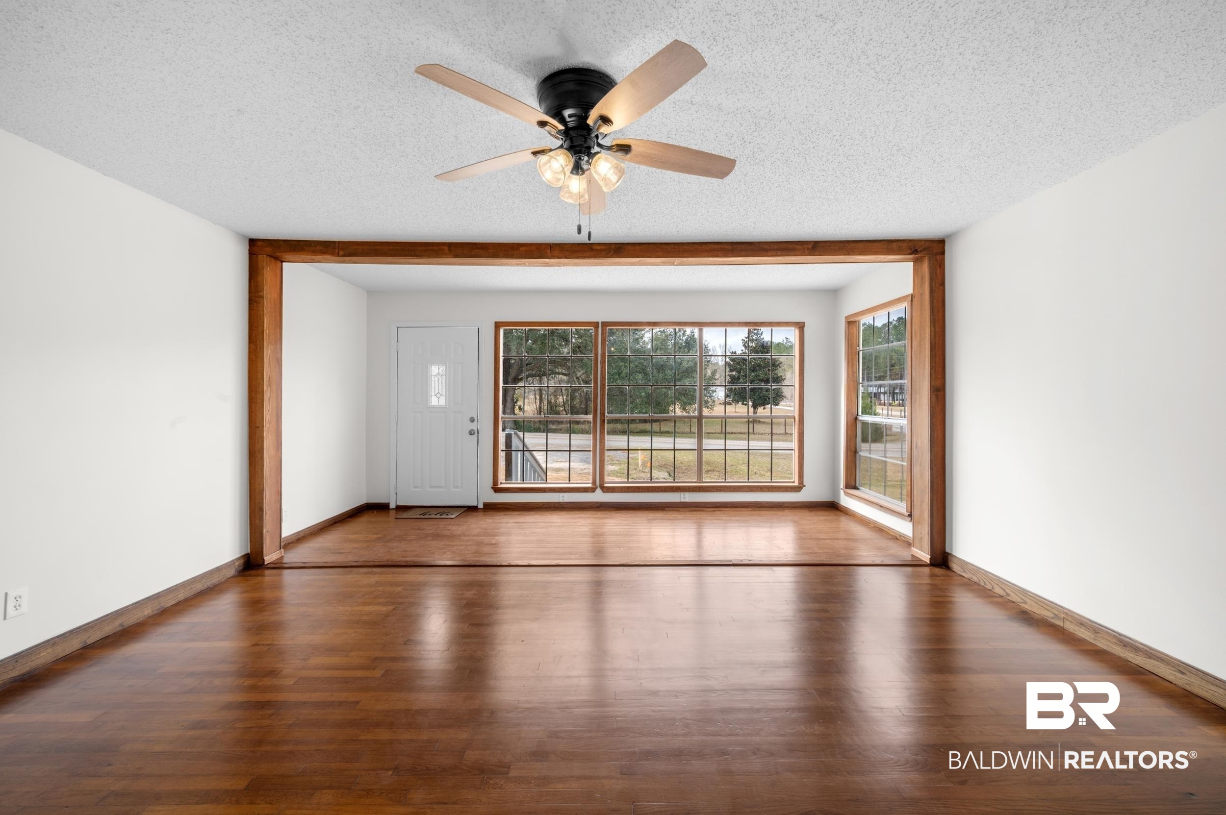 35780 Spring Road North Stapleton, AL 36578 - Photo 12 of 41 Unfurnished room with dark wood-style floors, a textured ceiling, and ceiling fan
