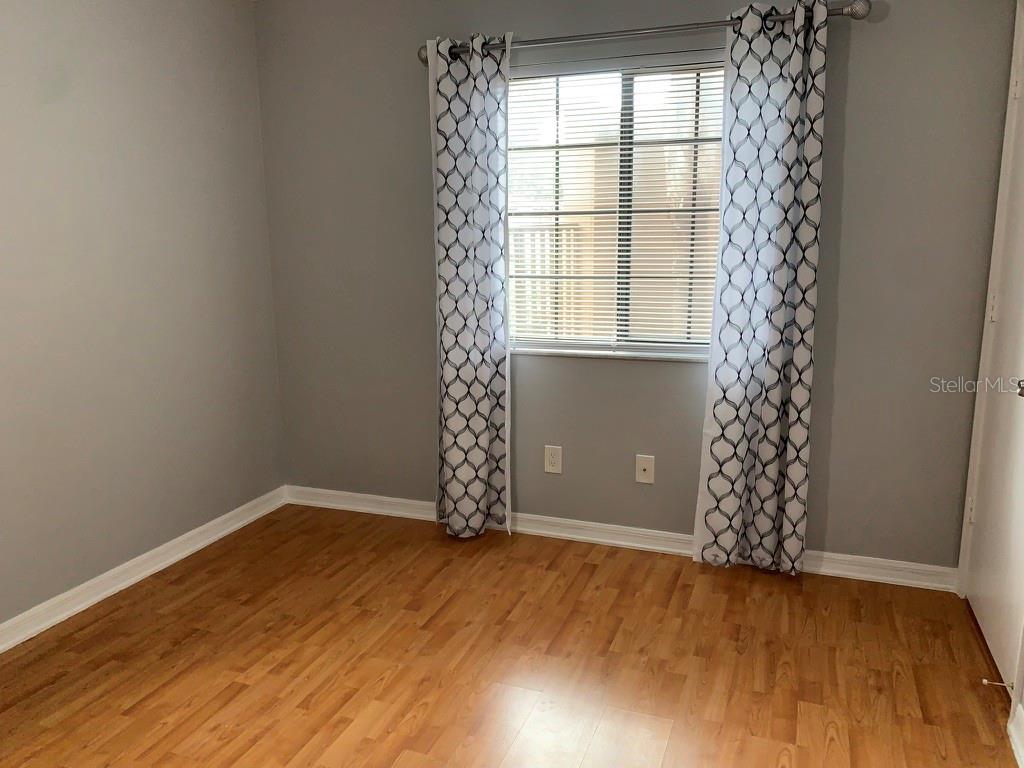 5754 Southwest 8th Place Gainesville, FL 32607 - Photo 22 of 29 a view of an empty room with window and wooden floor