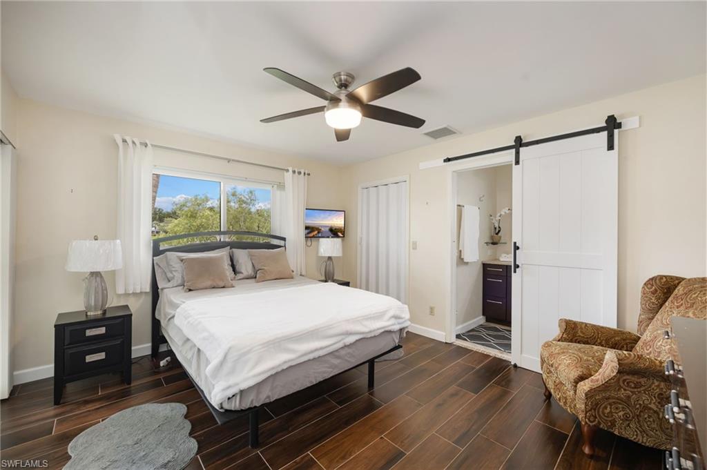 1324 Monarch Circle Naples, FL 34116 - Photo 12 of 23 a bedroom with a bed and wooden floor