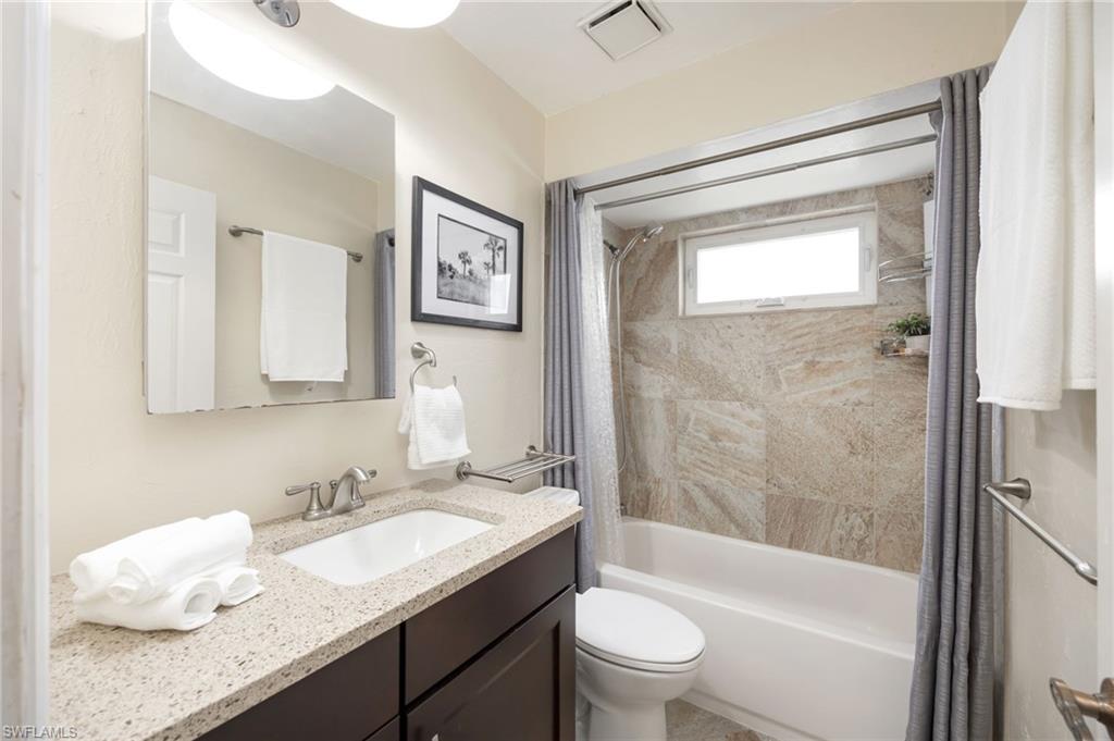 1324 Monarch Circle Naples, FL 34116 - Photo 13 of 23 a bathroom with a granite countertop sink toilet and shower