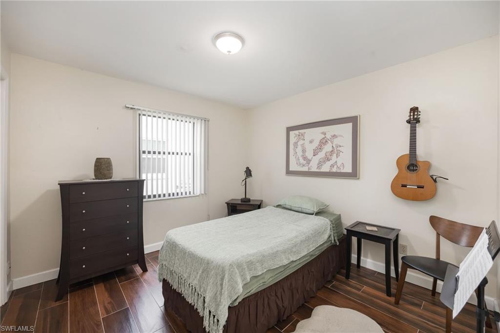 1324 Monarch Circle Naples, FL 34116 - Photo 14 of 23 a bedroom with a bed and a table