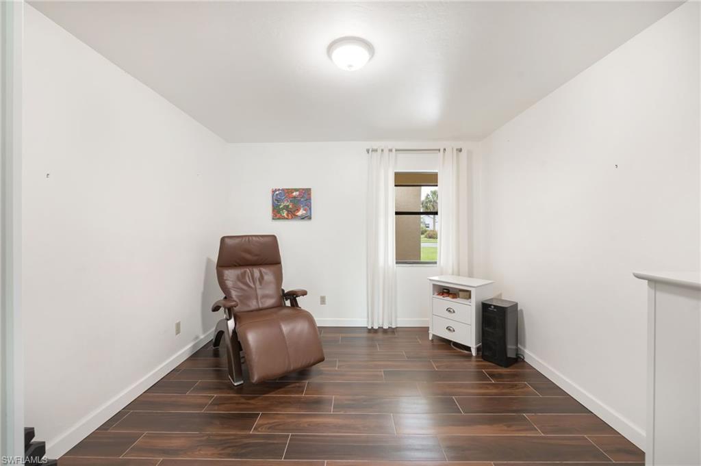 1324 Monarch Circle Naples, FL 34116 - Photo 15 of 23 a room with furniture and wooden floor