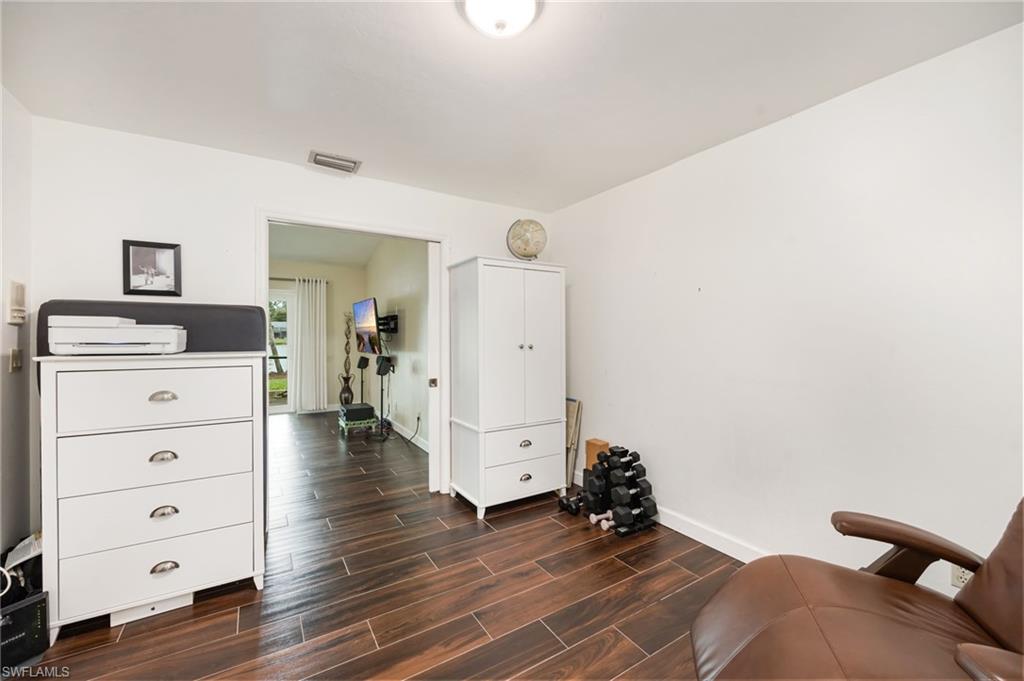 1324 Monarch Circle Naples, FL 34116 - Photo 16 of 23 a bedroom with a bed and a dresser