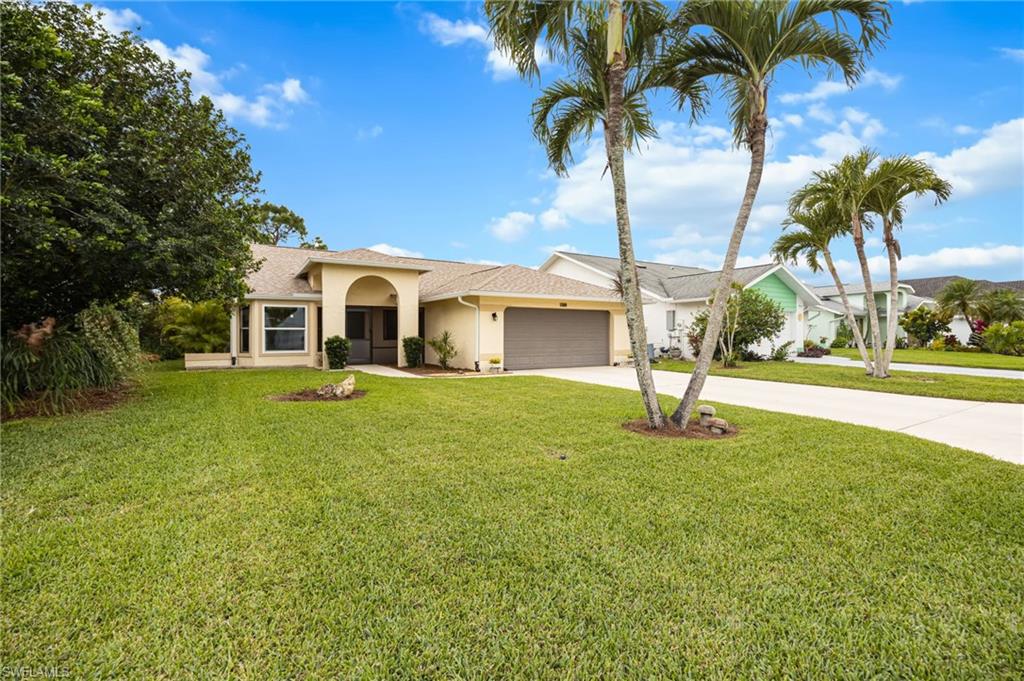1324 Monarch Circle Naples, FL 34116 - Photo 21 of 23 a front view of house with yard and green space