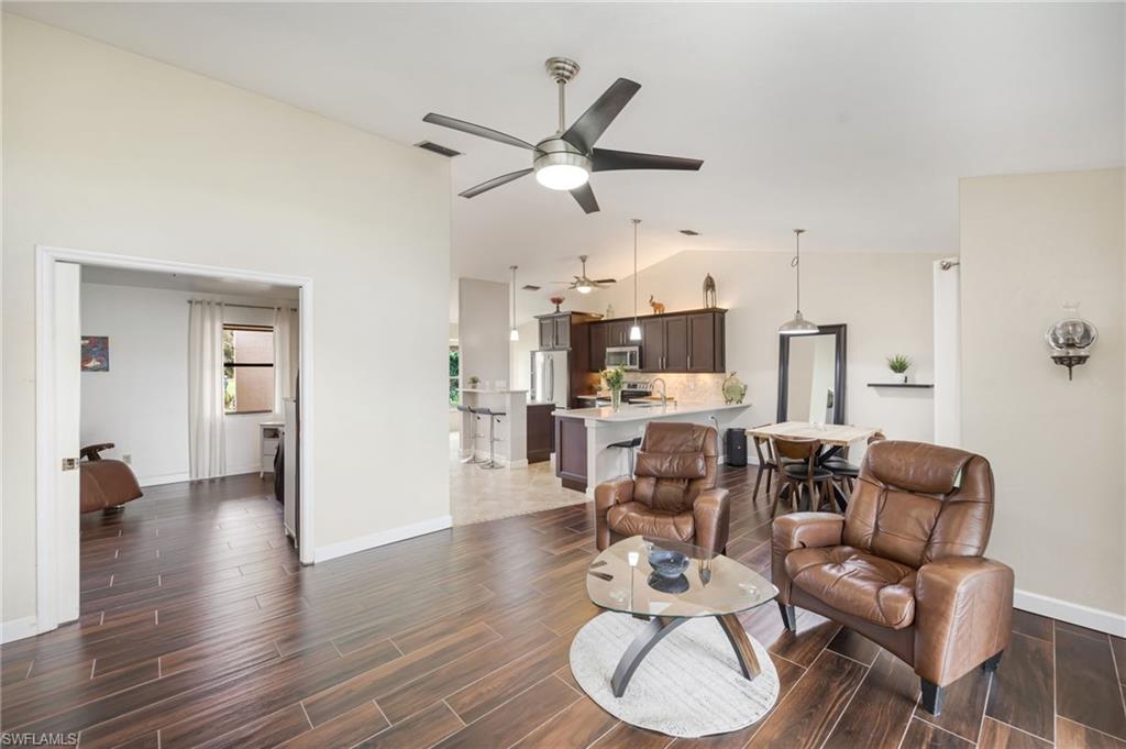 1324 Monarch Circle Naples, FL 34116 - Photo 8 of 23 a living room with furniture a ceiling fan and a wooden floor