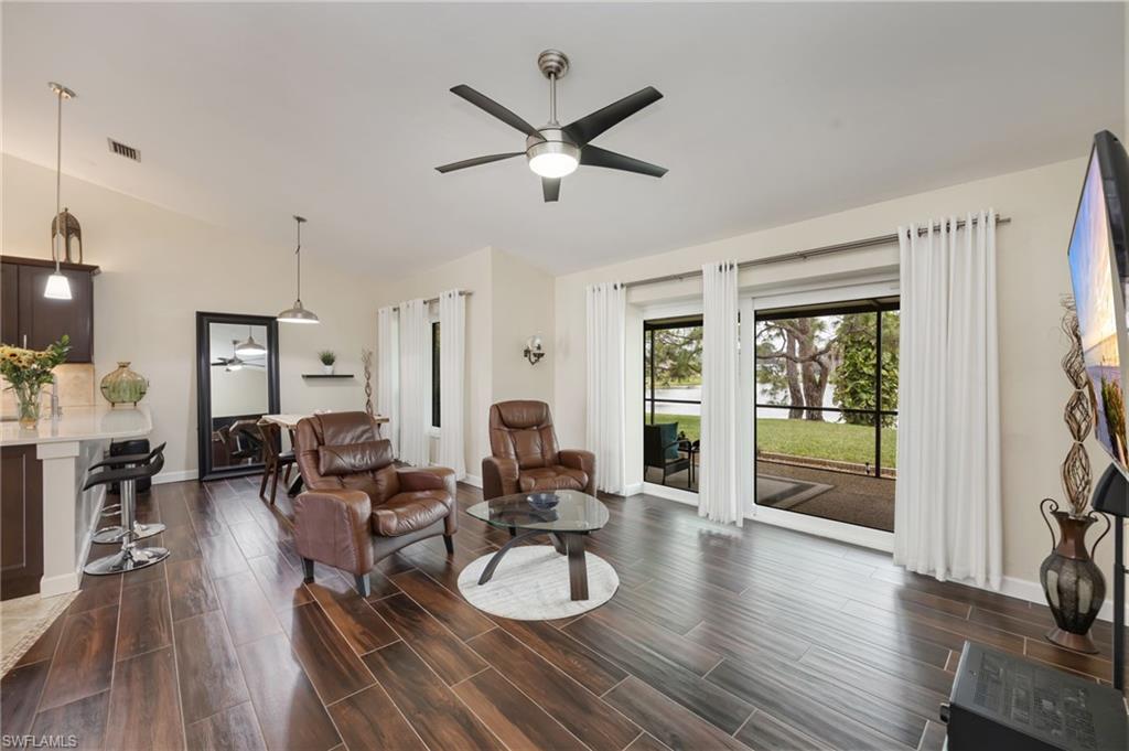 1324 Monarch Circle Naples, FL 34116 - Photo 10 of 23 a very nice looking living room with wooden floor and furniture