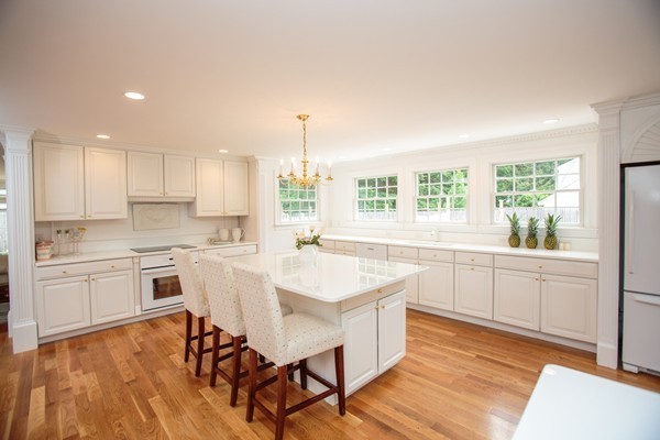6 Bay State Road Wellesley, MA 02481 - Photo 5 of 18 a kitchen with white cabinets and white appliances