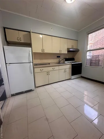 a kitchen with a cabinets and white appliances
