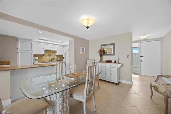 a living room with furniture and kitchen view