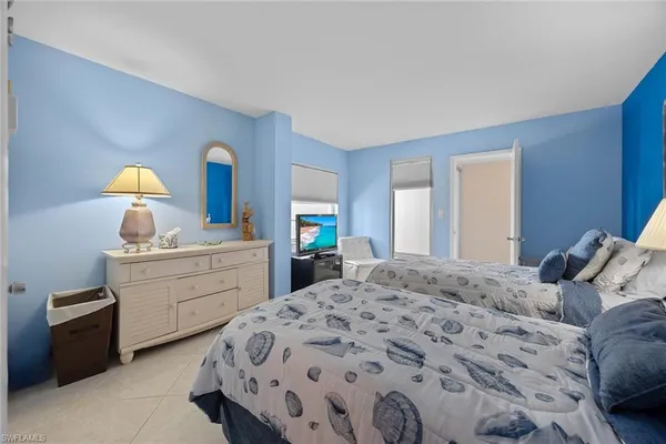 a bedroom with a bed and a dresser