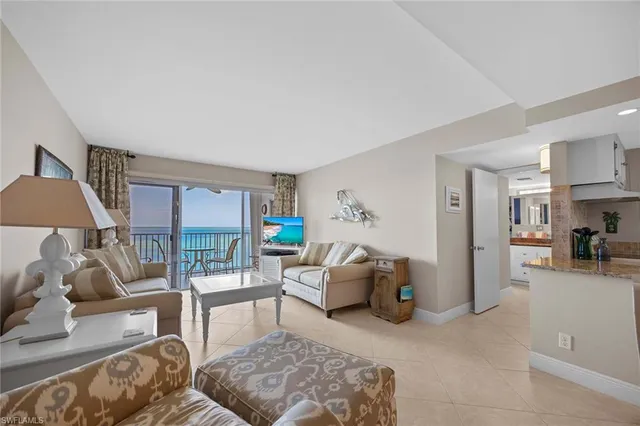 a living room with furniture and a lamp